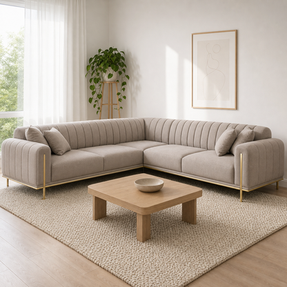 Astra - L shape sectional sofa in light-taupe fabric with gold-colored trim, two-arm corner sectional in a modern living room
